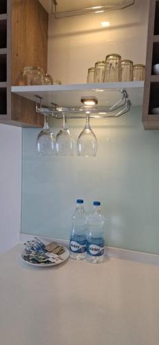 two bottles of water sitting on a counter in a kitchen at Luxury Sea View Apartments in Negombo