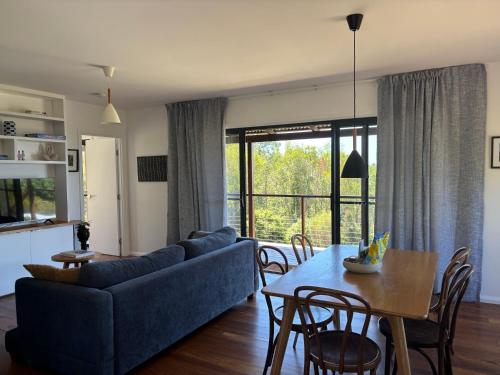 a living room with a blue couch and a table at Girayir Cottage in Federal