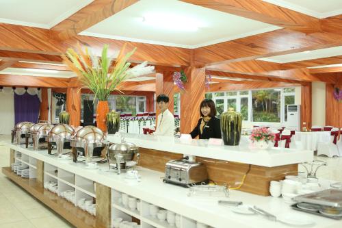 two women standing behind a counter in a restaurant at Muong Thanh Lai Chau Hotel in Pan Linh