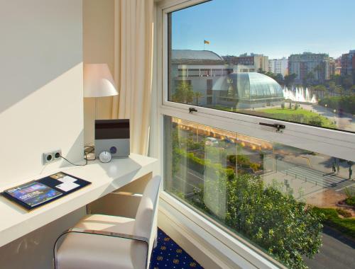 an office with a desk and a large window at SH Valencia Palace in Valencia