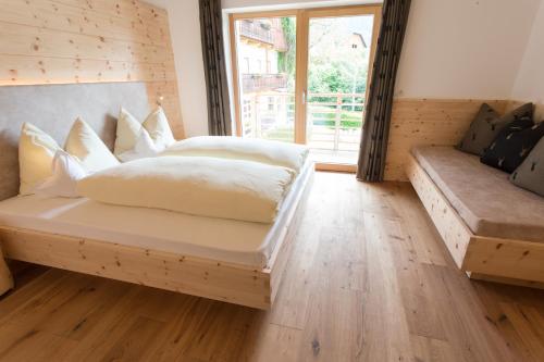 a bedroom with a bed and a couch at Bauernhofresidence Leierhof in Rodengo