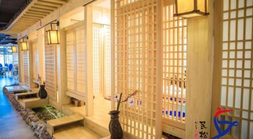 a room with bamboo walls and vases in a building at Yanji Yanbian International Hotel in Yanji