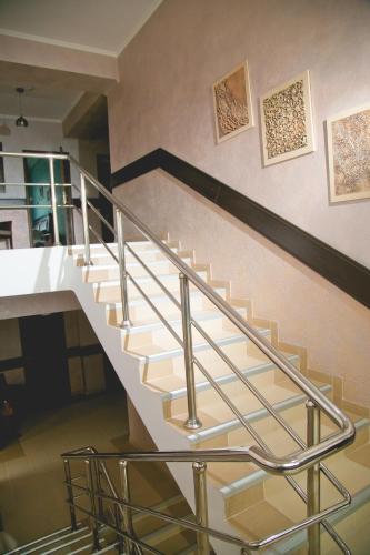 a staircase in a house with metal railings at Totem Hotel in Shymkent