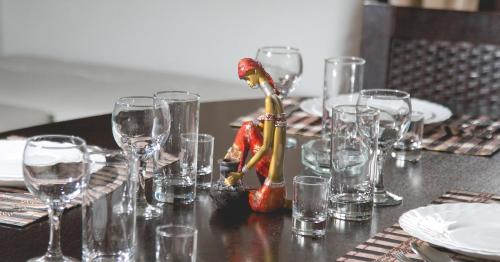 a table with empty wine glasses on it at Totem Hotel in Shymkent