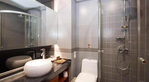 Un baño con inodoro, lavabo y ducha. en James Joyce Coffetel Xian Dayanta Metro Station Branch, en Xi'an