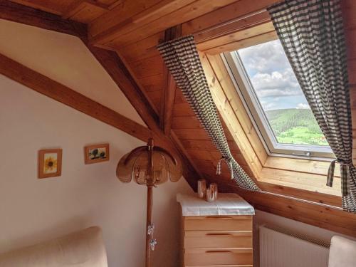 a room with a large window and a floor lamp at Pension Talblick in Baiersbronn