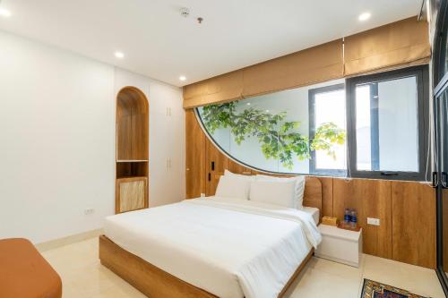 a bedroom with a large bed and a large window at Azure Bay Hotel in Ha Long