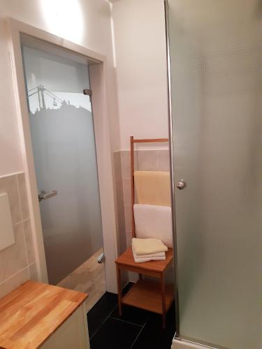 a bathroom with a door and a table and a mirror at 2-Personen-Apartment in Oberwiesenthal