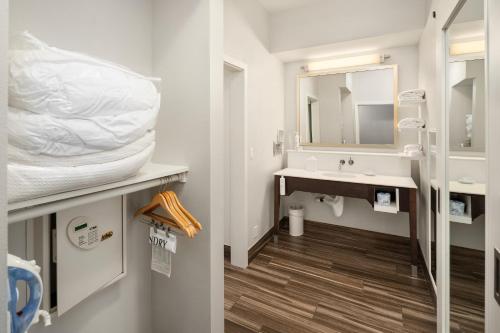 a white bathroom with a sink and a mirror at Hampton Inn & Suites Seattle North/Lynnwood in Lynnwood