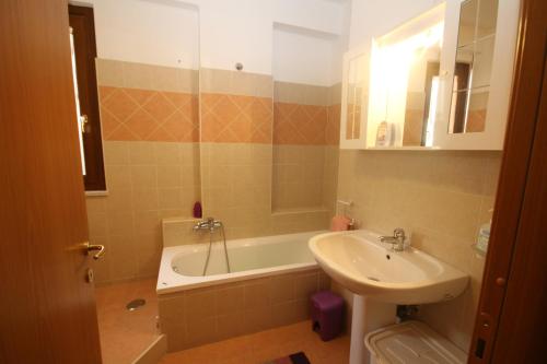 a bathroom with a sink and a bath tub and a sink at Universal Apartments Itri C in Itri