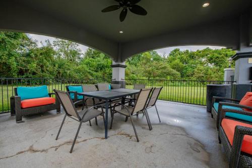 a patio with a table and chairs and a fence at Comfort Suites Oil Center in Lafayette