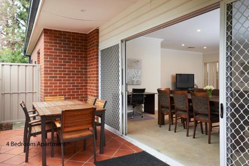 a dining room with a table and chairs at The Charles in Wagga Wagga