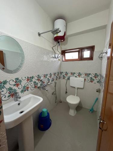 a bathroom with a sink and a toilet at Shenga Homestay in Ravangla