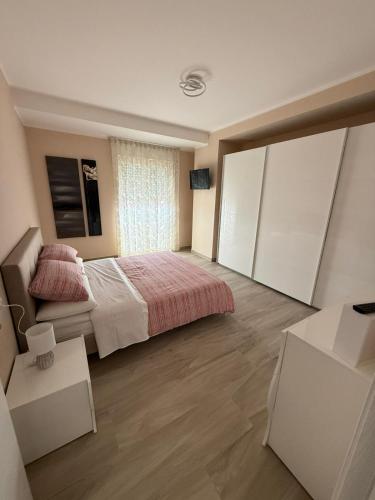a bedroom with a bed and a large window at Casa Edo in Avezzano