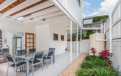 a dining room with a table and chairs at Brook place - 2BR Unit in Brisbane