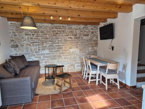a living room with a couch and a table at Akvamarin Stone House in Medulin