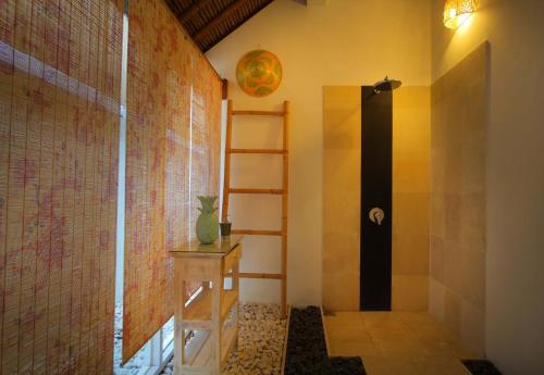 a bathroom with a walk in shower and a shelf at Villa Blue Pearl by Optimum Bali Villas in Seminyak