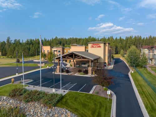 an aerial view of a building with a parking lot at Hampton Inn & Suites Whitefish in Whitefish