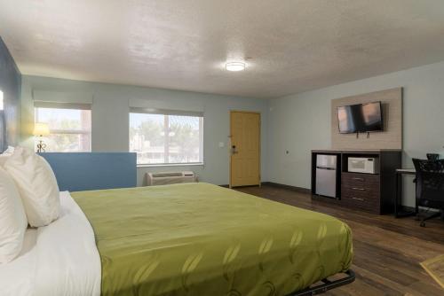 a hotel room with a bed and a flat screen tv at Quality Inn & Suites Manitou Springs at Pikes Peak in Manitou Springs