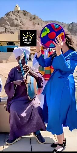 a group of people dressed in costumes posing for a picture at Sun City in Aswan