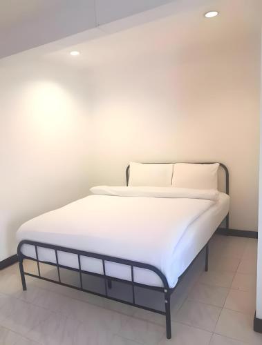 a bed with white sheets and pillows in a room at GO INN Patong Beach Phuket - โกอินน์ ป่าตอง Pro in Patong Beach