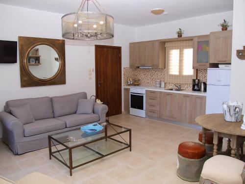 a living room with a couch and a table at Melograno Apartments and Studios in Kala Nera