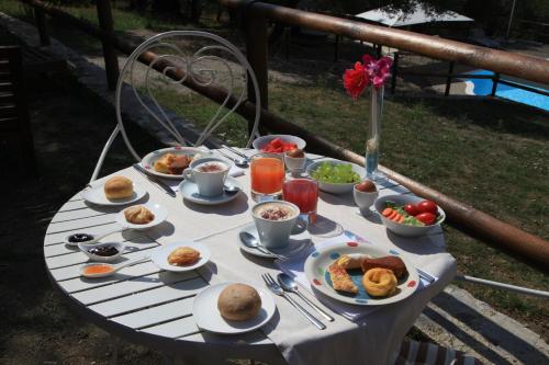 a table with plates of food on it at Tenuta Terre di Bosco Oasi di Relax nel Cilento in San Giovanni a Piro