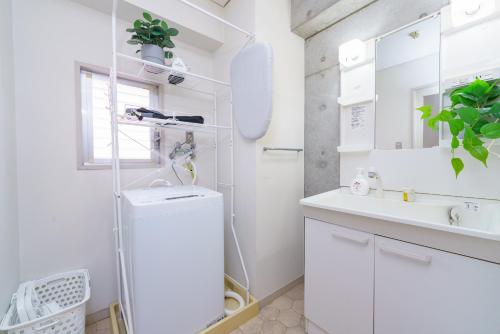 a white bathroom with a sink and a mirror at Central Nagoya! 15 min from Sta 2 Beds Max7 Family in Nagoya