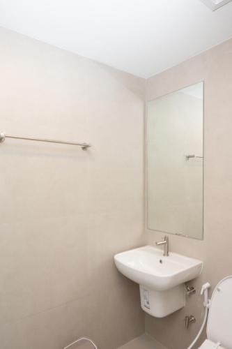 a white bathroom with a sink and a mirror at Timber Hotel in Ban Bang Rathuk