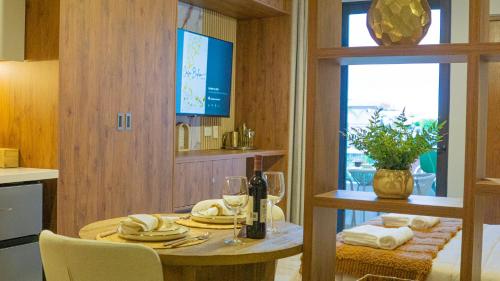 a kitchen with a table with plates and wine glasses at Luxury Studio in the heart of Playa del Carmen in Playa del Carmen