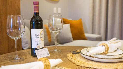 a bottle of wine sitting on a table with two wine glasses at Luxury Studio in the heart of Playa del Carmen in Playa del Carmen