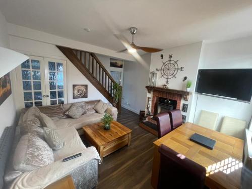 a living room with a couch and a table at Town House Ideal for working professionals in Stoke on Trent