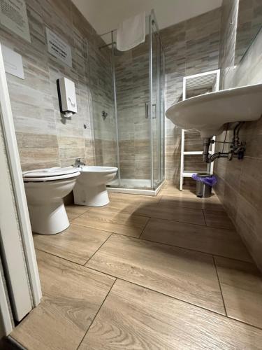 a bathroom with a sink and a toilet and a shower at Via Trento 30 in Salerno
