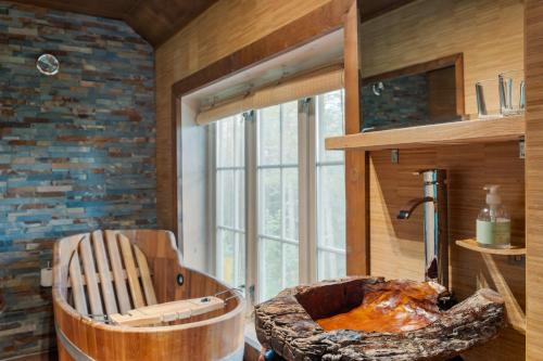 a room with a wooden chair and a large window at Herangtunet Mountain Lodge in Heggenes
