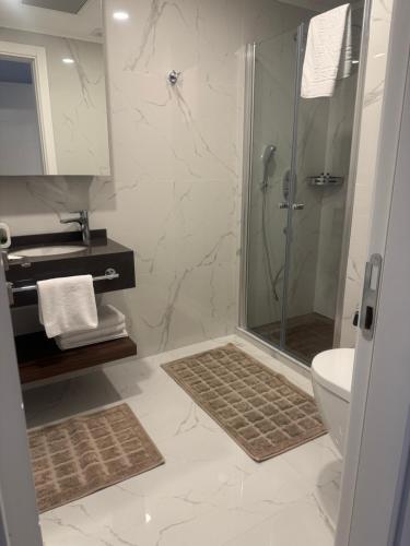 a bathroom with a shower and a toilet at Grand Sapphire Casino 1 bdr 002 in Iskele