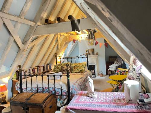 a bedroom with a bed in a attic at Walsingham Bakehouse in Little Walsingham