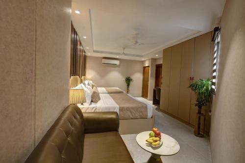 a hotel room with a bed and a couch at Hotel Deluxe Stay Inn Delhi Airport in New Delhi