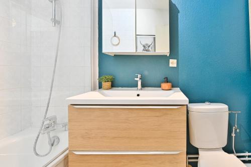 a bathroom with a sink and a toilet at Candella in Strasbourg