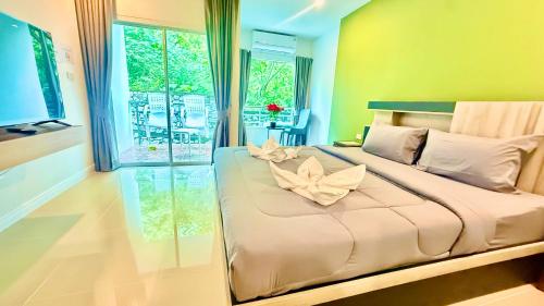 a bedroom with a large bed with flowers on it at Abdullah Residence in Patong Beach