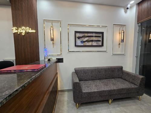 a waiting room with a chair and a counter at Hotel The King Palace in New Delhi