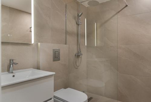 a bathroom with a shower and a toilet and a sink at Avyra Residences Chrysakama Sea View in Polis Chrysochous