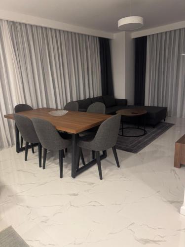 a living room with a wooden table and chairs at Grand Sapphire Casino 12 in Iskele
