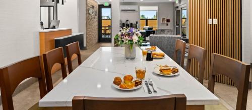 a table with plates of food and flowers on it at The Kulshan Hotel in Sedro-Woolley