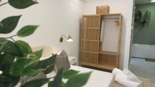 a bathroom with a mirror and a plant in the foreground at Viana apartaments in Bilbao