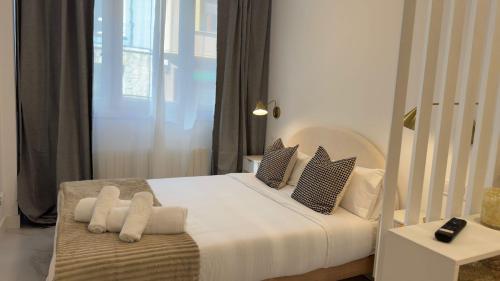 a bedroom with a large white bed with pillows at Viana apartaments in Bilbao