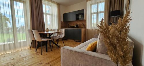 a living room with a couch and a table at Villa Olea in Tihany