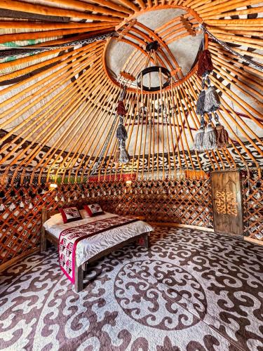 a bedroom with a bed in a yurt at Ethnochill Karakol yurt camping in Karakol