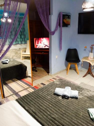 a bedroom with a bed and a tv and a mirror at Ottoman House in Thessaloniki