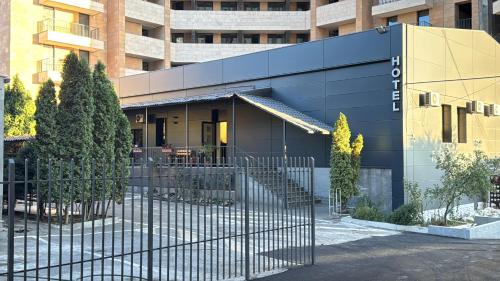 a building with a fence in front of it at Home inn hotel in Yerevan