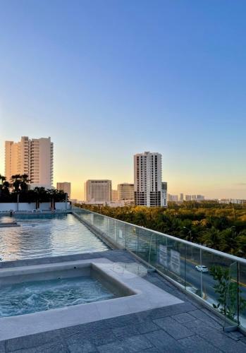 a swimming pool with a city skyline in the background at Casa Buddha - Pool, Jacuzzi and private terrace in Cancún